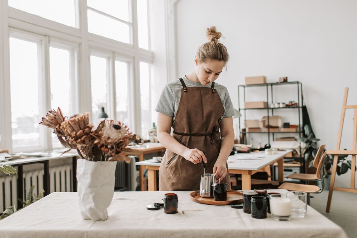 Artesã produzindo velas artesanais em ateliê